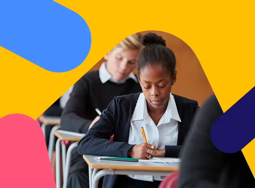 Pupils working at individual desks in an exam